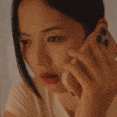 a close up of a woman talking on a cell phone with a case that says samsung on it