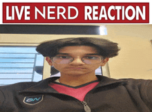 a young man wearing glasses and a black jacket is standing in front of a sign that says " live nerd reaction "