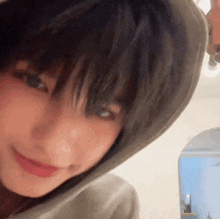 a close up of a person wearing a hooded sweatshirt .