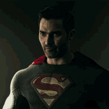 a man in a superman costume has a red cape