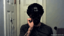 a man wearing a helmet has a tattoo on his arm that says ' a ' on it
