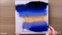 a person is painting a sunset on a canvas with wow art written on the bottom