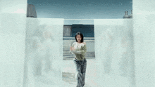 a woman in a green sweater is dancing in front of a group of dancers