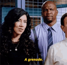 a group of people are standing next to each other and one of them is talking about a grenade .