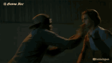 a man and a woman are fighting in a dark room with the words # cobra kai above them