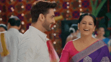 a man and a woman are dancing together and smiling at each other