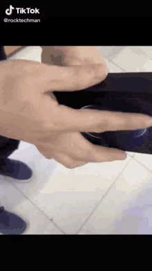 a tiktok video of a person holding a phone with their fingers