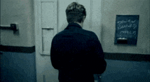 a man stands in front of a blackboard that says ' typical sunday ' on it