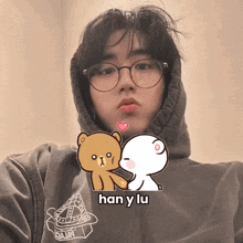 a boy wearing glasses and a hoodie with han y lu on it