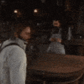 a man is taking a picture of a woman in a bar .