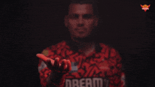 a man wearing a red shirt with the word dream on it