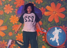 a woman in a sss t-shirt is laying on a floral background
