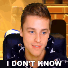 a young man is sitting in a chair with the words i don 't know on his face