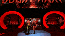 two women are standing next to each other on a stage in front of a red aew logo .