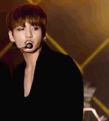 a young man wearing a microphone in his mouth