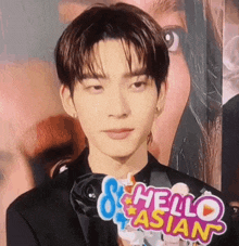 a close up of a young man with a hello asian sign in front of him