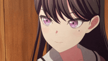 a close up of a girl with purple eyes and black hair