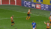 soccer players on a field with sky bet advertisements
