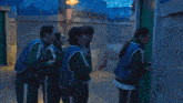 a group of people wearing green and blue vests with the number 806 on them