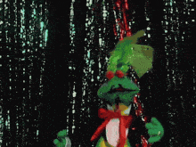 a green creature with red eyes is dancing in front of a black background