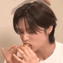 a close up of a person eating something with their hands
