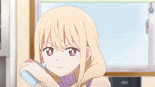 a girl in a purple sweater is holding a soap bar in her hand