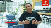 a man wearing a black t-shirt that says robert kubica