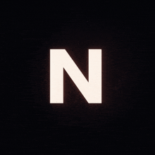the letter n is glowing in the dark against a black background