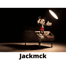 a picture of mickey mouse sitting on a couch with the name jackmck underneath it