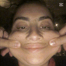 a close up of a woman making a funny face with her hands