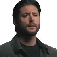 a man with a beard is wearing a jacket and a black shirt