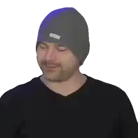a man with a beard wearing a gray beanie laughing