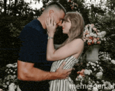 a man and a woman are kissing in front of flowers with meme-gen.at in the lower right corner
