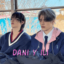 two young men sitting next to each other with the words dani y li written in pink