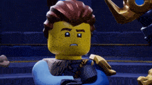 a close up of a lego character with a serious expression on his face