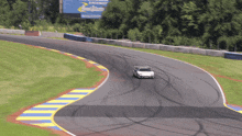 a race car is going down a track with a sign that says raceway