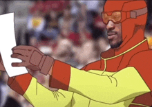 a man in a superhero costume is holding a piece of paper