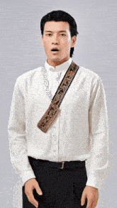 a man wearing a white shirt and black pants has a purse on his shoulder