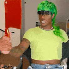 a man with green hair is holding a knife in his hand