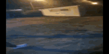 a person is standing on a flooded street at night .