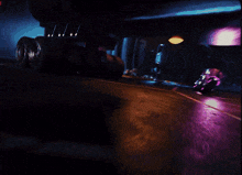 a purple light shines on a dark background