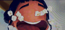 a close up of a cartoon character with popcorn coming out of her eyes .