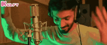 a man is singing into a microphone in a recording studio .