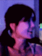 a blurry picture of a person 's face with a purple light behind them and a purple background