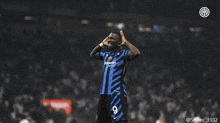 a soccer player wearing a number 9 jersey talks to another player