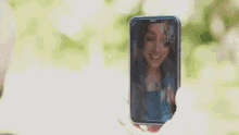 a person is taking a picture of a woman on a cell phone