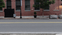 a street with a brick building and a sign that says ' boston '
