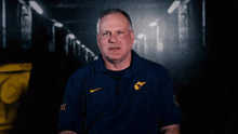 a man in a blue shirt with the word west virginia written on it