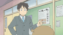 a man in a suit and tie is standing in front of a bulletin board