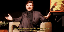 a man in a suit and turtleneck says i am an asshole